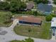 A bird's eye view captures this property with long driveway and fenced backyard at 7150 Orange Way, Lakeland, FL 33810