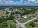 Overhead shot displays the home's location within a lush, green residential area at 7150 Orange Way, Lakeland, FL 33810