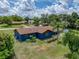 The backyard has a well-manicured lawn with trees, a fence, and a screened-in porch at 7150 Orange Way, Lakeland, FL 33810
