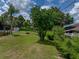 Lush backyard with mature trees and landscaping, offering a serene outdoor retreat at 7150 Orange Way, Lakeland, FL 33810