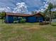 The home's backyard is grassy, private, and has a screened-in porch and some landscaping at 7150 Orange Way, Lakeland, FL 33810