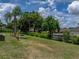 Lush backyard with a mix of grass, trees, and landscaping, creating a private outdoor space at 7150 Orange Way, Lakeland, FL 33810