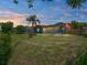 Expansive backyard featuring a large, well-maintained lawn, a screened-in patio, and mature trees at 7150 Orange Way, Lakeland, FL 33810
