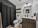 Clean bathroom featuring a shower, sink, modern lighting, and plank flooring at 7150 Orange Way, Lakeland, FL 33810