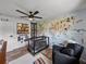 Stylish bedroom featuring a crib, an accent wall with animals, and a modern ceiling fan at 7150 Orange Way, Lakeland, FL 33810