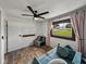 Bright bedroom featuring plank floors, a modern ceiling fan, and a window view at 7150 Orange Way, Lakeland, FL 33810