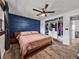 Spacious bedroom with a closet, king bed, blue accent wall, and wood flooring at 7150 Orange Way, Lakeland, FL 33810