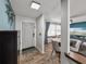 Entryway showing tile floors leading to a living room with a round dining table and comfortable seating at 7150 Orange Way, Lakeland, FL 33810