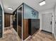 Stylish home entryway showcasing wood-look tile floors, contemporary storage cabinets, and decorative wall accents at 7150 Orange Way, Lakeland, FL 33810
