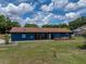 Charming blue single-story home with well-maintained lawn, brown roof, and inviting front entrance at 7150 Orange Way, Lakeland, FL 33810