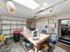 Well-lit garage interior, showcasing storage and work space, including a workbench, and a pegboard for tool organization at 7150 Orange Way, Lakeland, FL 33810