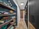 Hallway featuring wood plank flooring and a built-in shelving unit at 7150 Orange Way, Lakeland, FL 33810
