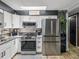 Well-lit kitchen with stainless steel refrigerator and modern finishes at 7150 Orange Way, Lakeland, FL 33810