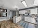 Modern kitchen with white cabinets, granite countertops, stainless steel appliances, and wood look tile floor at 7150 Orange Way, Lakeland, FL 33810