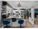 Open-concept kitchen featuring a breakfast bar with blue velvet stools at 7150 Orange Way, Lakeland, FL 33810