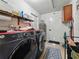 Bright laundry room with modern washer and dryer, storage, and convenient access to utilities at 7150 Orange Way, Lakeland, FL 33810