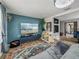 Inviting living room with blue accent wall, large TV, and stylish decor at 7150 Orange Way, Lakeland, FL 33810