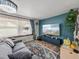 Bright living room with large windows, a comfortable couch, and a modern TV at 7150 Orange Way, Lakeland, FL 33810
