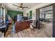 Office area with wood floors, views to the Gathering room, and natural light at 7150 Orange Way, Lakeland, FL 33810
