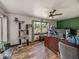 Office with wood floors, cat tree, and a green accent wall at 7150 Orange Way, Lakeland, FL 33810