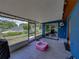 Enclosed patio with tile flooring, grill, kiddie pool, and view of backyard, perfect for relaxation at 7150 Orange Way, Lakeland, FL 33810