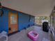 View of an enclosed patio with tile flooring, grill, and a kiddie pool in the backyard at 7150 Orange Way, Lakeland, FL 33810