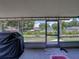Covered back patio featuring tile flooring, grill and relaxing view of landscaped backyard at 7150 Orange Way, Lakeland, FL 33810