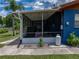Cozy screened sunroom with access to the backyard and perfect for outdoor dining and relaxing at 7150 Orange Way, Lakeland, FL 33810