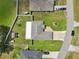 Birds-eye view of a house and yard, showcasing a well-maintained lawn, shed, and nearby street at 8219 Rangers Path, Lakeland, FL 33809