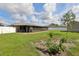Spacious backyard with a small tree and screened patio with eating area at 8219 Rangers Path, Lakeland, FL 33809