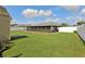 Lush green backyard with screen enclosed patio and a storage shed at 8219 Rangers Path, Lakeland, FL 33809
