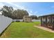 Spacious backyard featuring a storage shed, lush green lawn, and privacy fence at 8219 Rangers Path, Lakeland, FL 33809