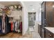 This primary bathroom features a walk-in shower, dual vanities, tile flooring and a walk-in closet at 8219 Rangers Path, Lakeland, FL 33809