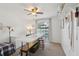 Bright bedroom featuring a large arched window, ceiling fan, workstation, and custom storage solutions at 8219 Rangers Path, Lakeland, FL 33809
