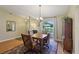 Charming dining room with large arched window, hardwood floors, and traditional decor at 8219 Rangers Path, Lakeland, FL 33809
