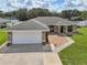 Charming single-story home featuring a two-car garage, neutral paint, meticulous landscaping and inviting curb appeal at 8219 Rangers Path, Lakeland, FL 33809