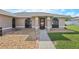 Welcoming front entrance with decorative stone landscaping and a modern front door at 8219 Rangers Path, Lakeland, FL 33809
