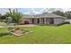 Beautiful single-story home with a well-manicured lawn and lovely landscaping at 8219 Rangers Path, Lakeland, FL 33809