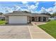 Charming single-story home with a two-car garage and well-maintained front yard at 8219 Rangers Path, Lakeland, FL 33809