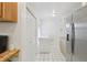Bright kitchen with stainless steel fridge, white tile floors, and lots of storage at 8219 Rangers Path, Lakeland, FL 33809