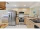 Efficient kitchen featuring stainless steel appliances, light wood cabinets and neutral countertops at 8219 Rangers Path, Lakeland, FL 33809