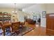 Open-concept living room features hardwood floors, vaulted ceiling and sliding door to lanai at 8219 Rangers Path, Lakeland, FL 33809