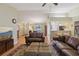 Open living area with hardwood floors and views of the kitchen and dining room at 8219 Rangers Path, Lakeland, FL 33809