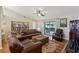 Spacious living room with bookshelves and a sliding glass door to the outdoor patio at 8219 Rangers Path, Lakeland, FL 33809