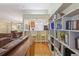 Inviting living room flowing into kitchen, featuring hardwood floors and custom built-in bookshelves at 8219 Rangers Path, Lakeland, FL 33809