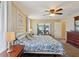 The well-lit main bedroom features a ceiling fan, neutral decor, and access to the patio at 8219 Rangers Path, Lakeland, FL 33809