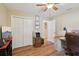 This home office features wood floors, a ceiling fan, and ample storage space with closet and cabinet solutions at 8219 Rangers Path, Lakeland, FL 33809