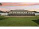 Enclosed sunroom with a wall of windows overlooking the lush green lawn at 8219 Rangers Path, Lakeland, FL 33809