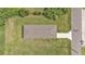 A top-down aerial view of a cozy home, featuring a well-maintained roof and expansive yard at 1025 Lakewood Ct, Lakeland, FL 33801