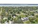 An aerial shot shows homes nestled among trees in a peaceful residential neighborhood by the water at 1025 Lakewood Ct, Lakeland, FL 33801